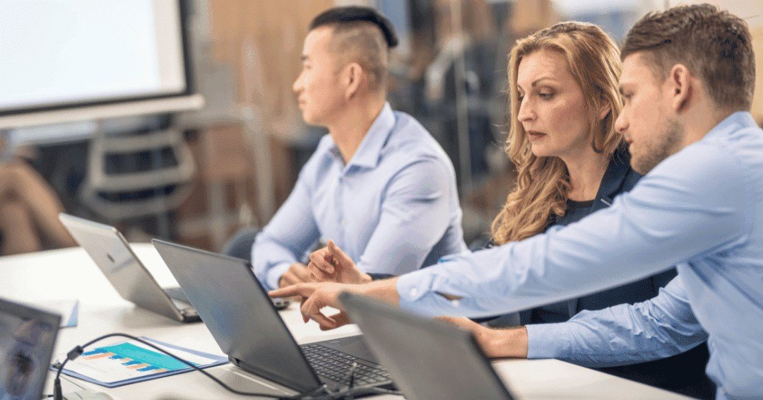 AP team reviewing payment errors on computer.